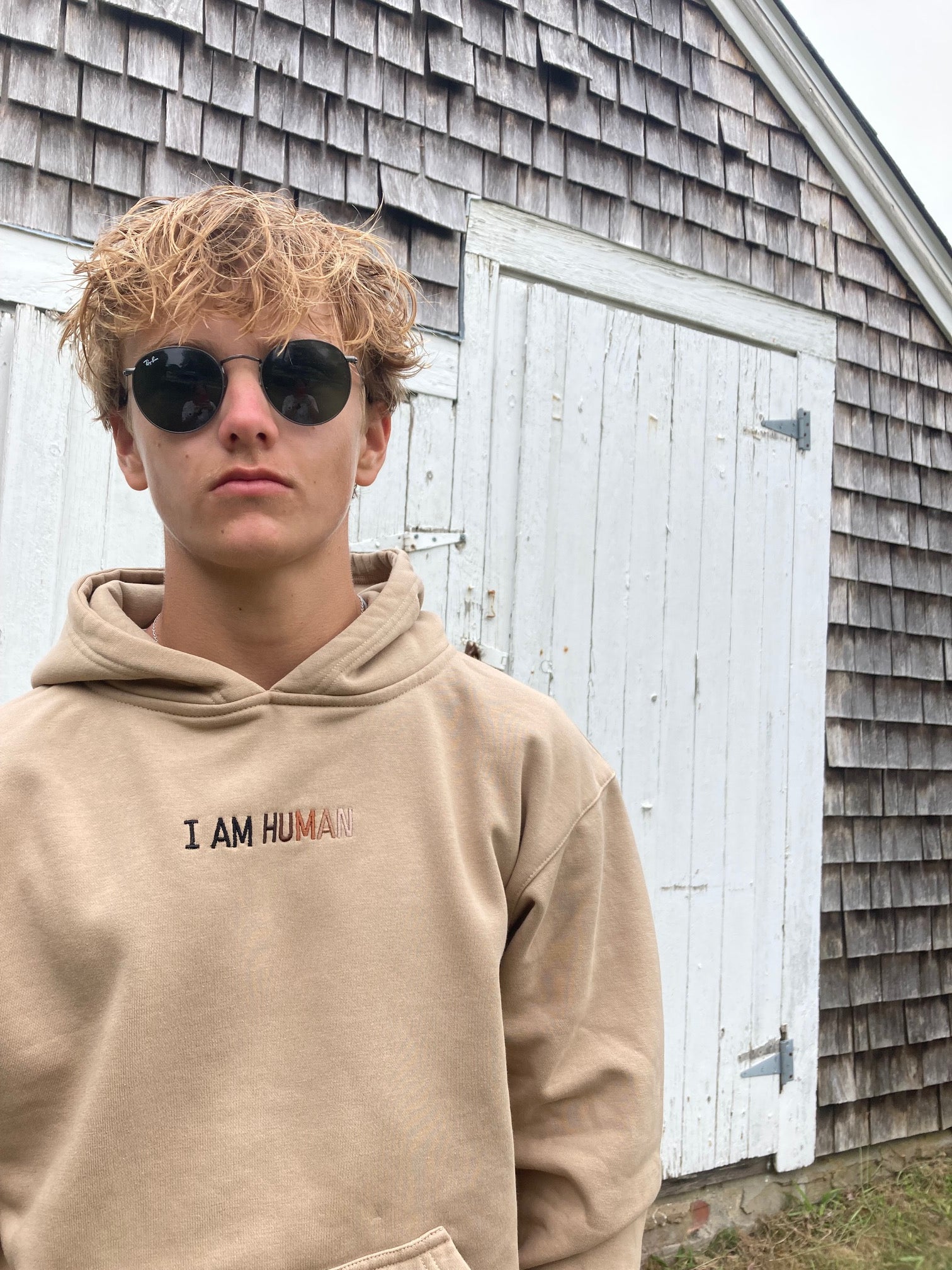 Robbie in I AM HUMAN logo hoodie facing forward.