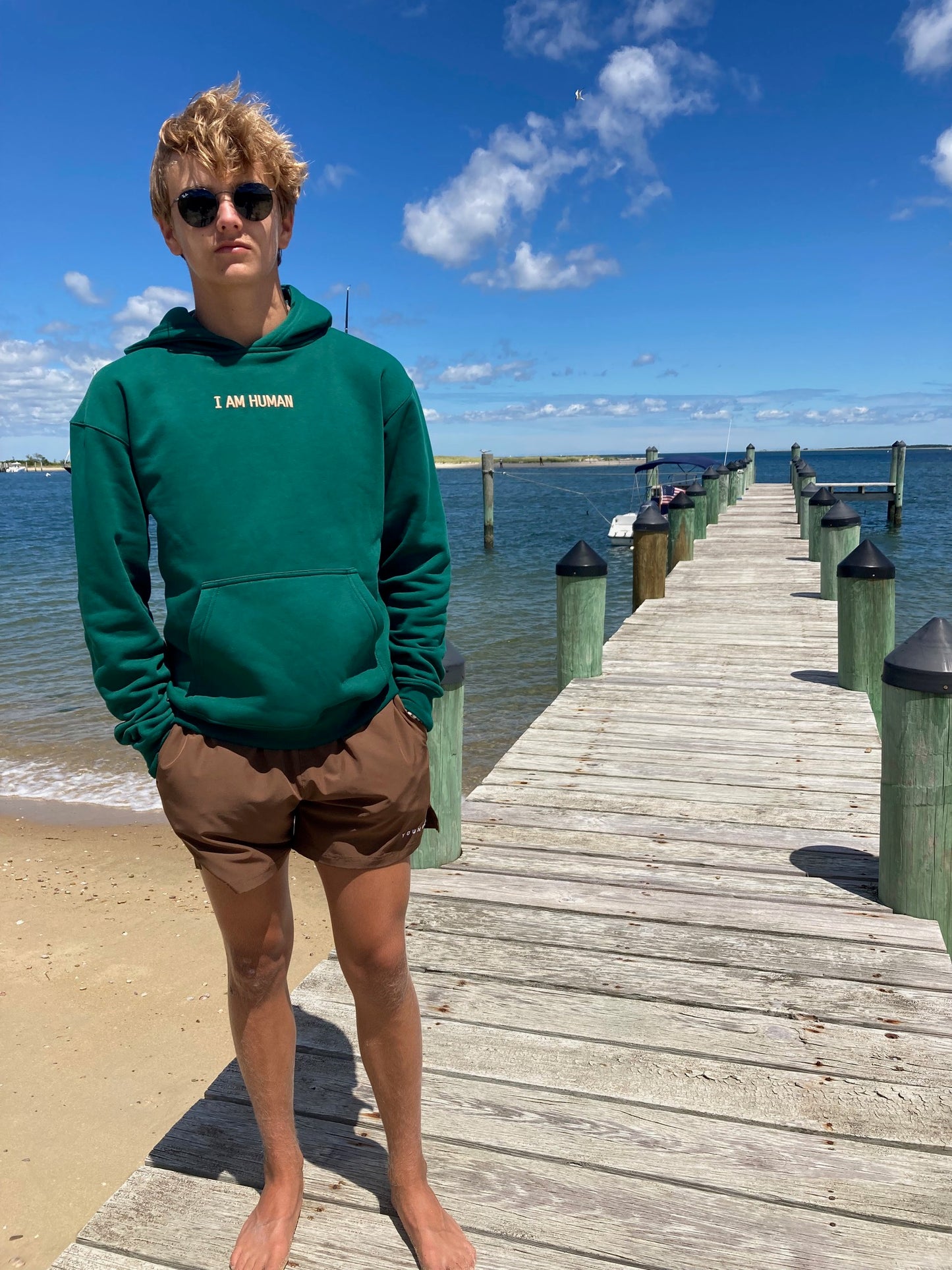 Front view of Robbie in green human definition hoodie.