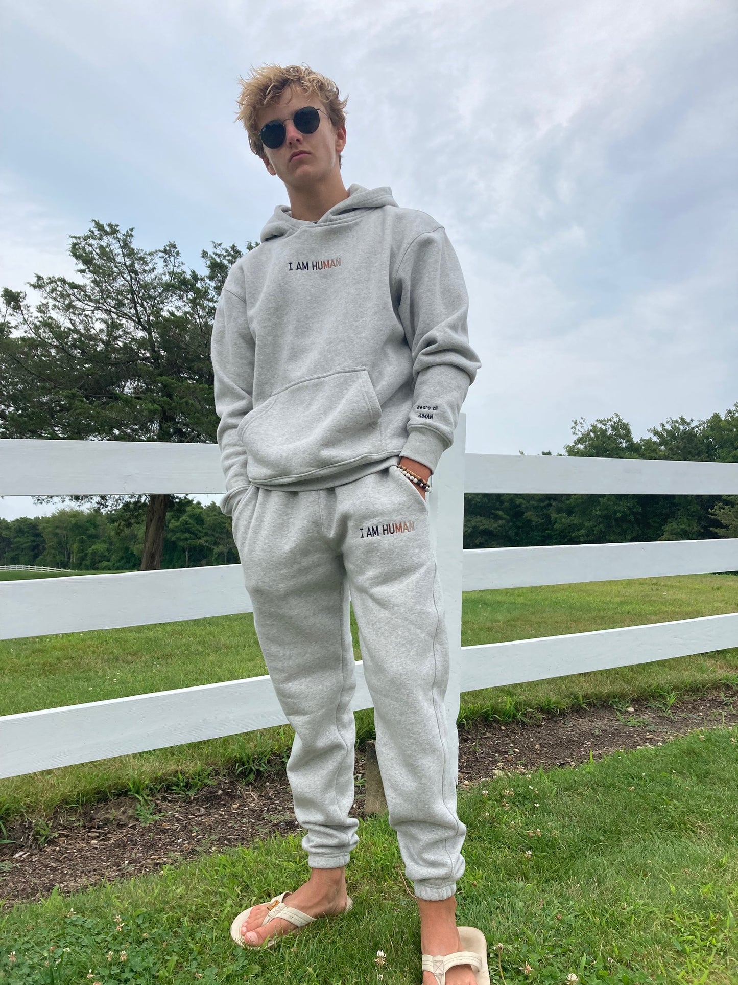 Front view of Robbie in medium grey logo joggers.