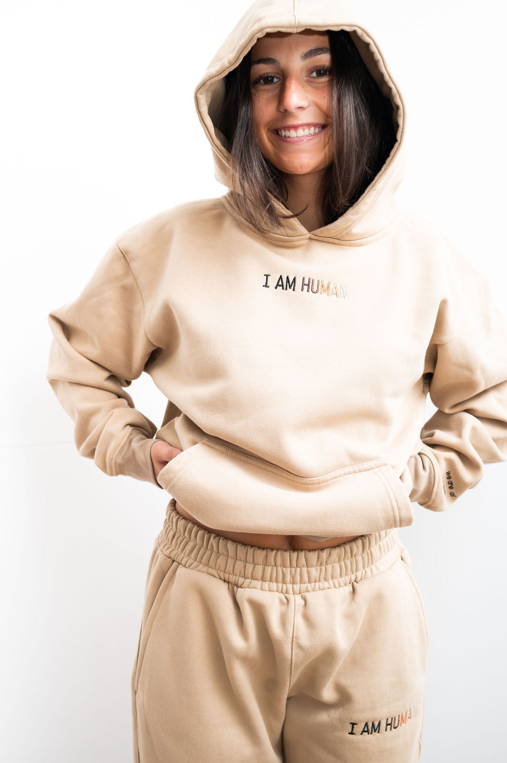 Close up of Elizabeth in tan I AM HUMAN logo hoodie.